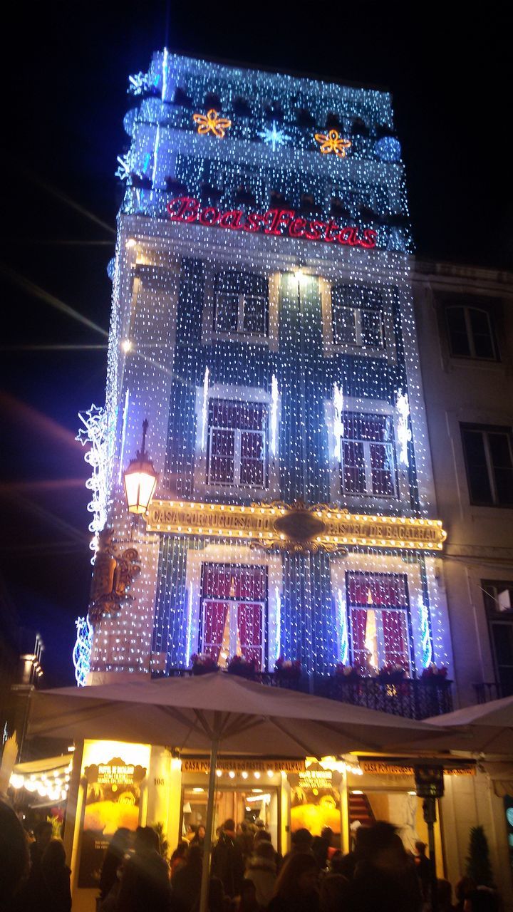 illuminated, night, architecture, built structure, building exterior, city, glass - material, lighting equipment, window, indoors, low angle view, modern, building, reflection, no people, transparent, light - natural phenomenon, hanging, decoration, skyscraper