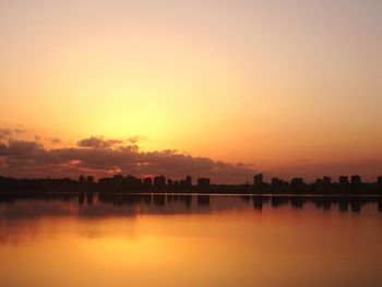 Scenic view of lake against romantic sky at sunrise