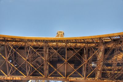 Low angle view of bridge against blue sky