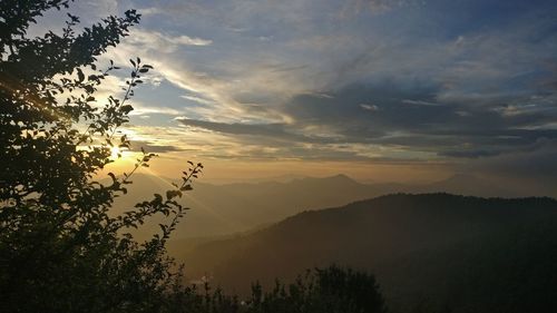 Scenic view of silhouette mountains against sky at sunset