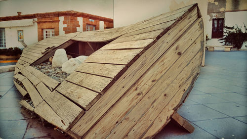 Close-up of wooden house against building