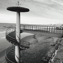 Lifeguard hut on beach against sky