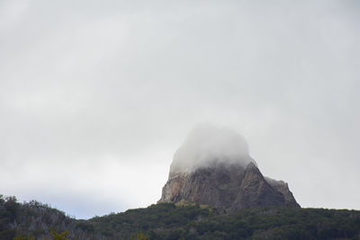 Low angle view of rock formations against sky