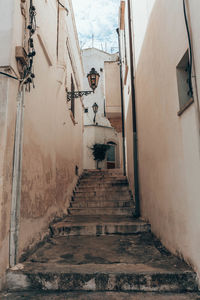 Narrow alley amidst buildings in town