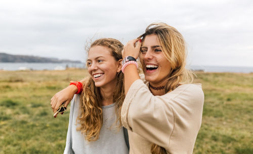 Two happy teenage girls near the coast