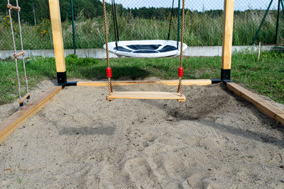 Rear view of man standing on swing