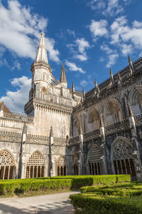 Low angle view of cathedral against cloudy sky