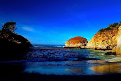 Scenic view of sea against blue sky