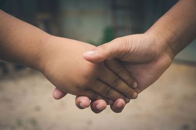 Close-up of hands holding baby hand