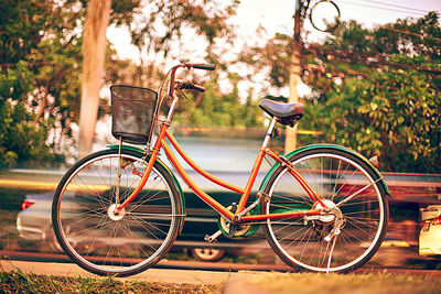 Bicycle parked by wooden wall