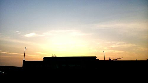 Low angle view of silhouette building against sky