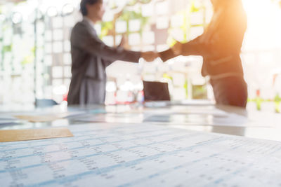 Surface level shot of business colleagues shaking hands in office