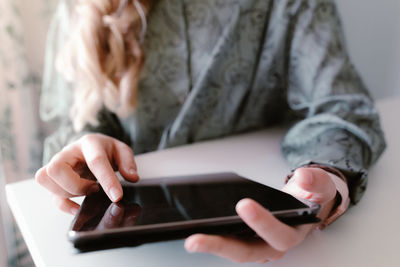 Midsection of man using mobile phone