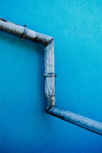 Close-up of blue pipe against blue wall