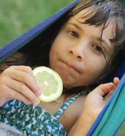 Close-up portrait of a woman holding fruit