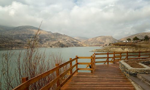 Pier over lake against sky