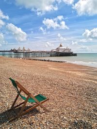 Scenic view of beach against cloudy sky