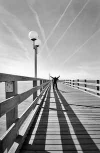 Man on railing against sky