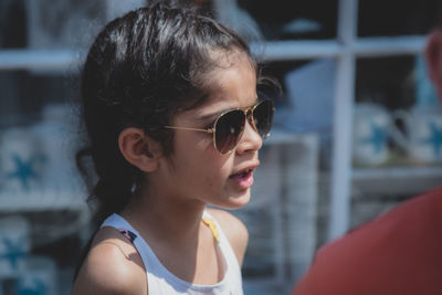 Close-up portrait of woman wearing sunglasses