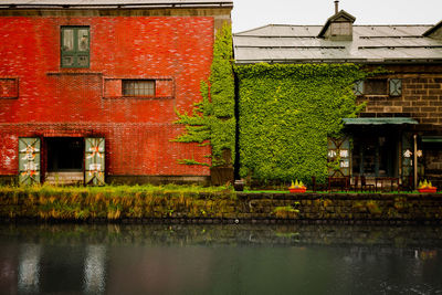 House by lake against building