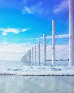 Bridge over sea against blue sky