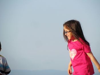 Girl standing against sky