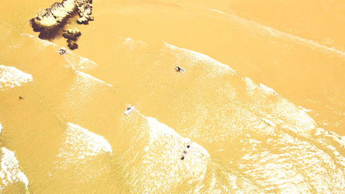 High angle view of sea waves on beach