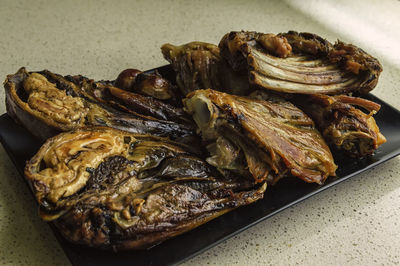 Close-up of roasted meat serving in plate