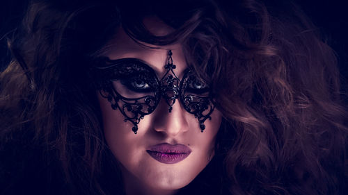 Close-up portrait of young woman wearing mask