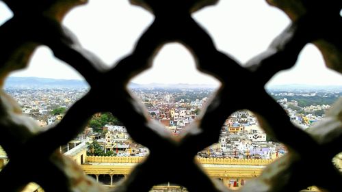 Close-up of cityscape seen through window