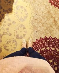 Low section of woman standing on carpet