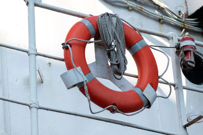 Low angle view of red flags hanging on metal structure