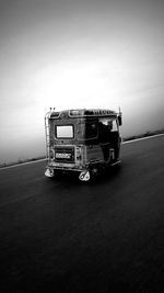 Vintage car on road against sky