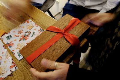 High angle view of human hand holding paper box