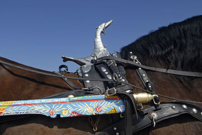 Low angle view of horse cart against sky