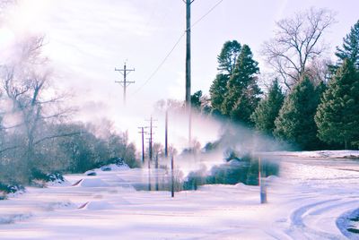 Snow covered land against sky during winter