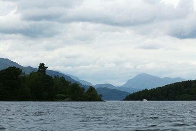 Scenic view of lake against cloudy sky