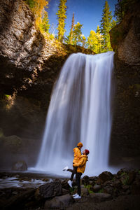 Rear view of waterfall against rocks