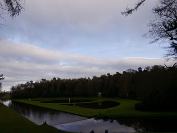 Scenic view of golf course against sky