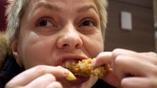 Close-up portrait of boy eating food