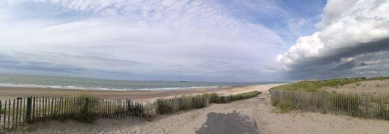 Scenic view of sea against cloudy sky