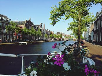 Scenic view of canal by building against sky