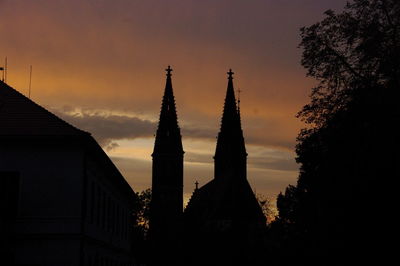Low angle view of silhouette trees against sky