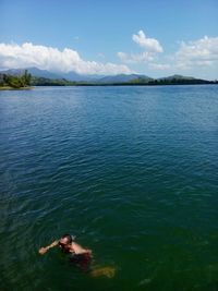 Scenic view of lake against cloudy sky