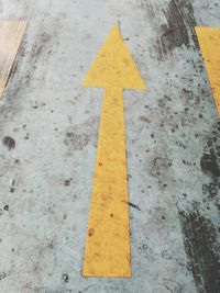 High angle view of arrow sign on road