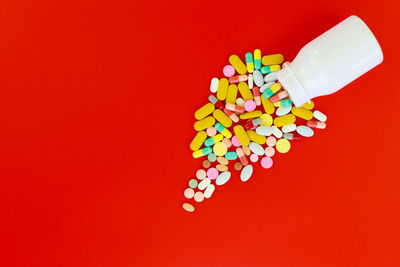 Close-up of colored pencils over red background