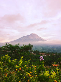 Scenic view of sea and mountains against sky