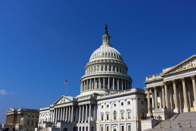 Low angle view of capitol building against clear blue sky