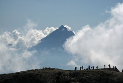 Scenic view of mountains against cloudy sky