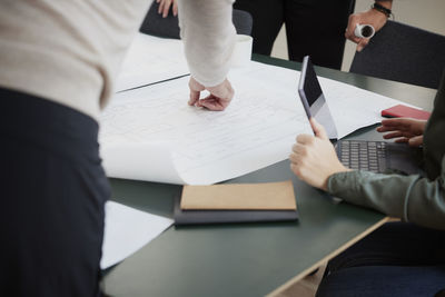 People looking at plans during meeting